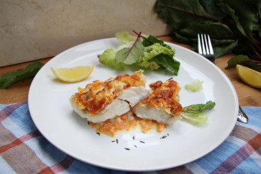 Hake in the oven with onions, carrots and sour cream