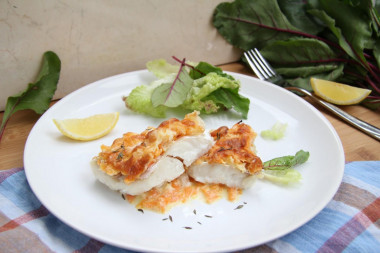 Hake in the oven with onions, carrots and sour cream