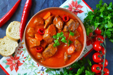 Beef goulash in a slow cooker with gravy