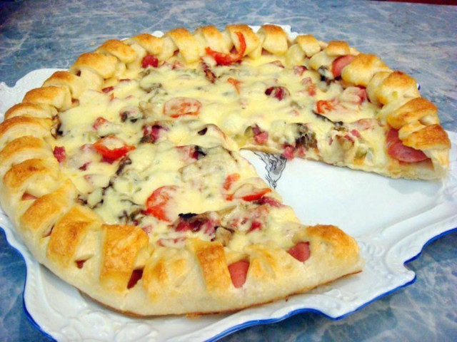 Festive pizza with pickles, sausages and sausage