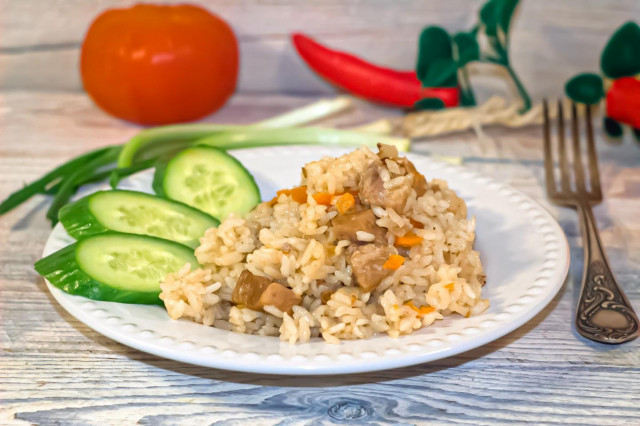 Classic pilaf with pork in a cauldron on the stove