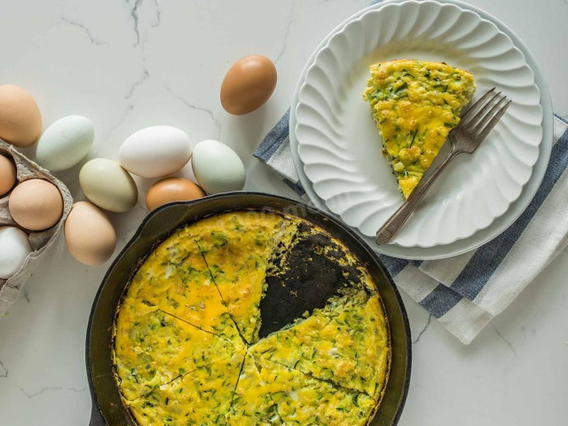 Zucchini casserole in a frying pan with egg