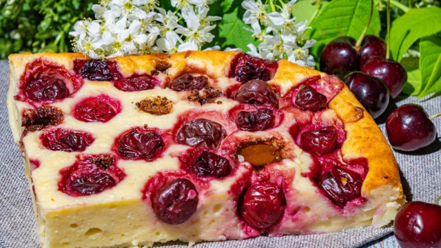 Berry pie with cherries on dough with cottage cheese and sour cream