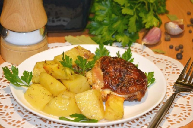 Chicken baked with potatoes with parsley under mayonnaise