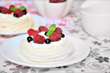 Delicious Meringue Pavlova cake with wild berries