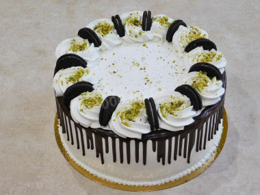 Cake with nuts, prunes, sour cream and cream