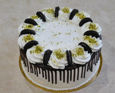 Cake with nuts, prunes, sour cream and cream