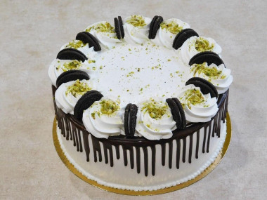 Cake with nuts, prunes, sour cream and cream