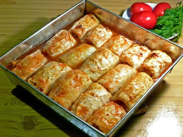 Stuffed cabbage rolls with minced meat in the oven in tomato sauce