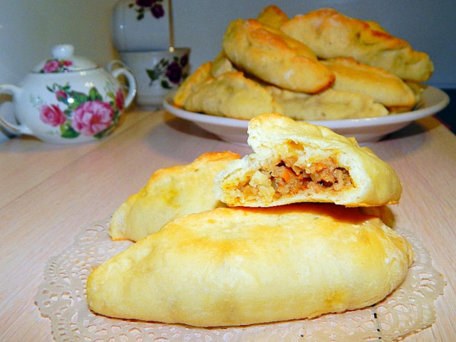 Yeast pastry pies with meat and potatoes