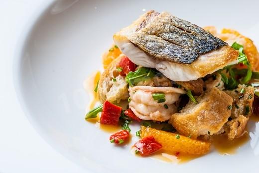 Baked sea bass with vegetables and herbs