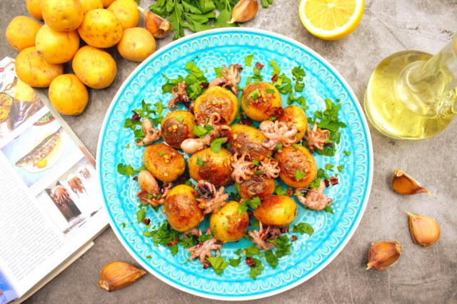 Small octopuses frozen in a frying pan with potatoes