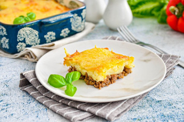 Potato casserole with minced meat and cheese in oven