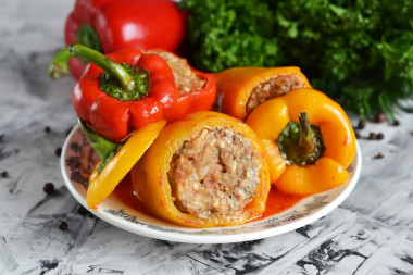 Stuffed peppers with tomato paste in a saucepan