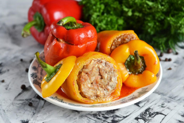 Stuffed peppers with tomato paste in a saucepan