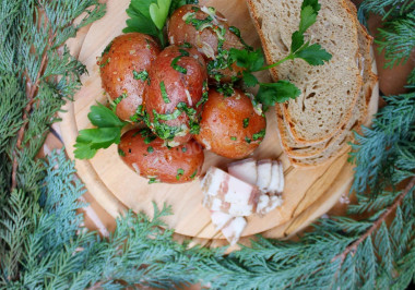 New potatoes with garlic in a uniform with fragrant dressing