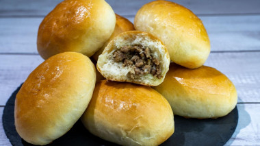 Yeast pies with meat filling in the oven