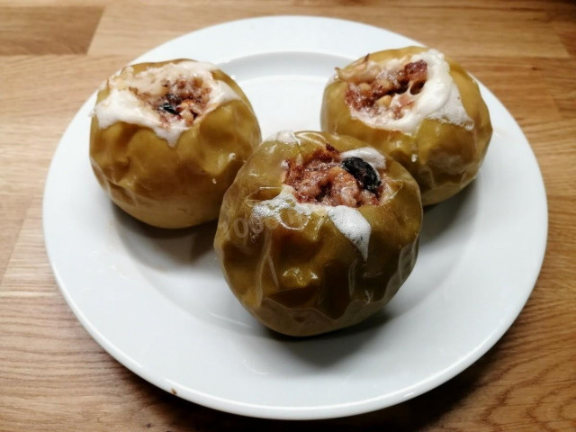 Baked apples with nuts and raisins in the oven