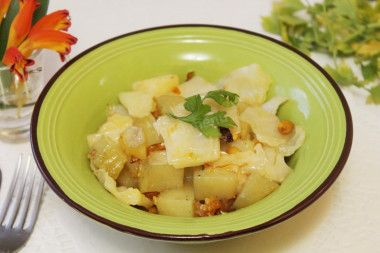 Potatoes with onions and cabbage stewed under foil in the oven