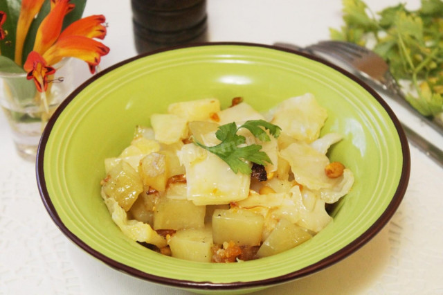 Potatoes with onions and cabbage stewed under foil in the oven