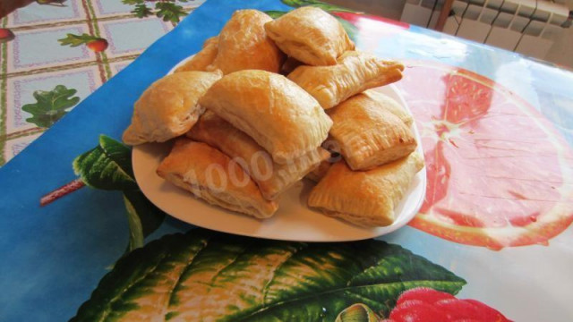 Puff pastry pies in the oven with egg filling