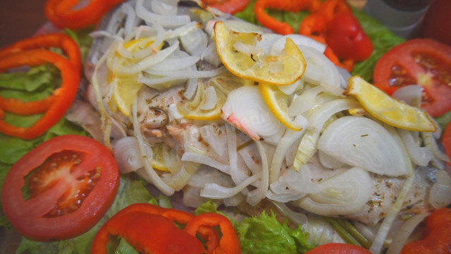 Pink salmon stuffed with vegetables in the oven