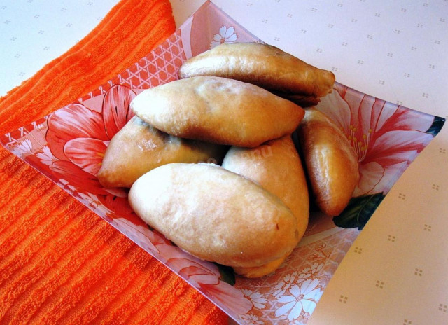 Yeast dough pies with cabbage filling in the oven