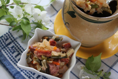 Stew with cabbage beans and smoked chicken in pots