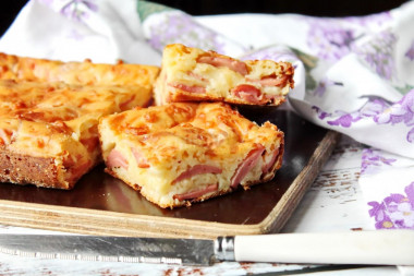 Aspic pie with sausages and grated cheese on kefir