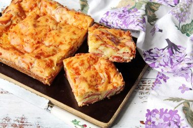 Aspic pie with sausages and grated cheese on kefir