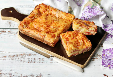 Aspic pie with sausages and grated cheese on kefir