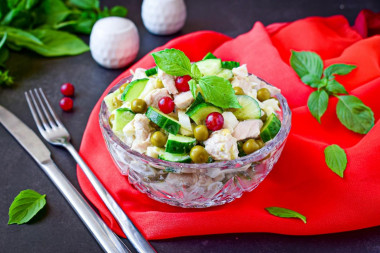 Salad with chicken, green peas, cucumber and egg