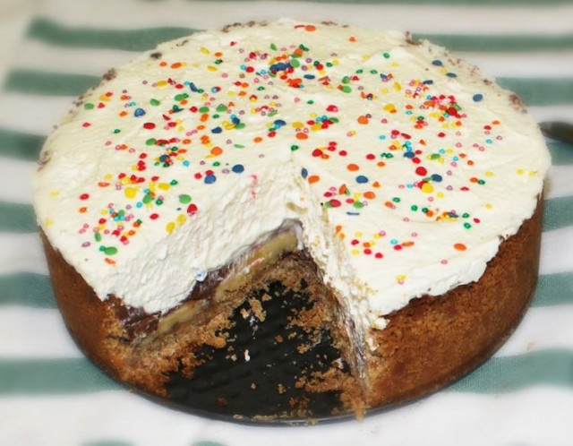 Banana cake with cookies and whipped cream