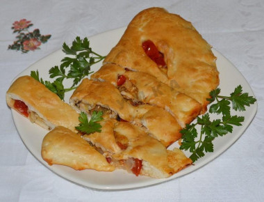 Closed pizza calzone with chicken and mushrooms