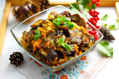 Fried honey mushrooms with onions in a frying pan