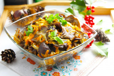 Fried honey mushrooms with onions in a frying pan