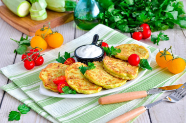 Fluffy zucchini pancakes on frying pan