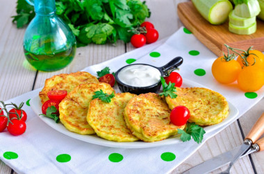 Fluffy zucchini pancakes on frying pan