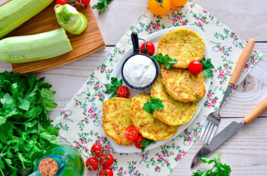 Fluffy zucchini pancakes on frying pan