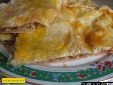 Strudel apple pie with raisins and nuts from puff pastry