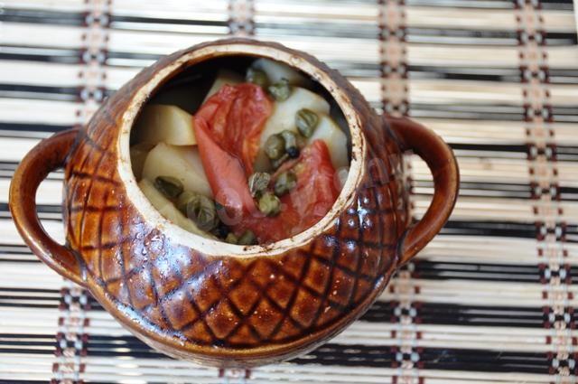 Ham in a pot with potatoes, mushrooms and tomatoes