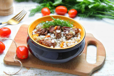 Pearl porridge with stewed meat in a frying pan