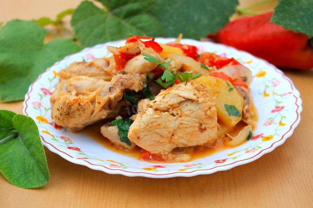 Chicken in a cauldron with vegetables on a campfire