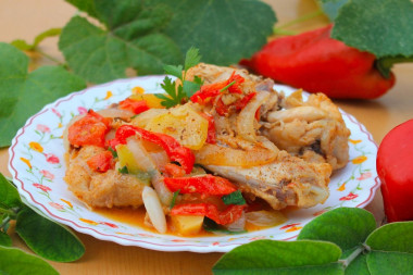 Chicken in a cauldron with vegetables on a campfire