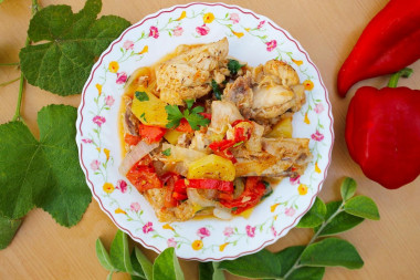 Chicken in a cauldron with vegetables on a campfire