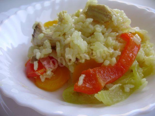 Rice with chicken and vegetables in a cauldron