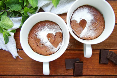 Chocolate cupcake in a mug in the microwave