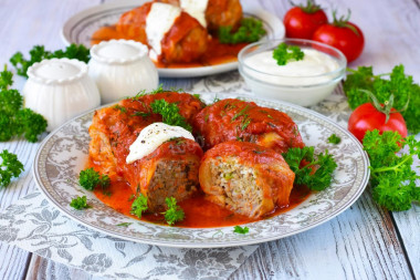 Frozen cabbage rolls in a saucepan with tomato paste