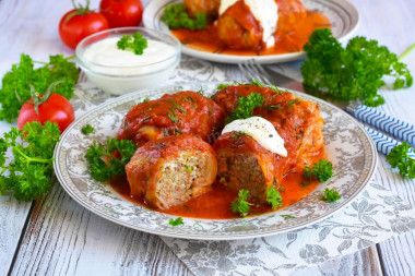 Frozen cabbage rolls in a saucepan with tomato paste