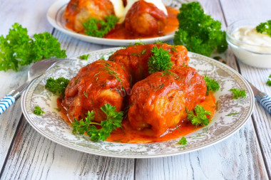 Frozen cabbage rolls in a saucepan with tomato paste